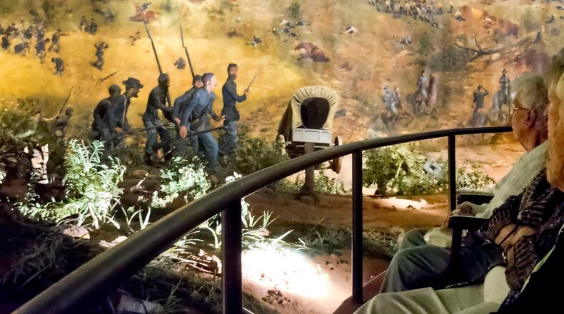 Visitors view a depiction of the 1864 battle of Atlanta at the Cyclorama.