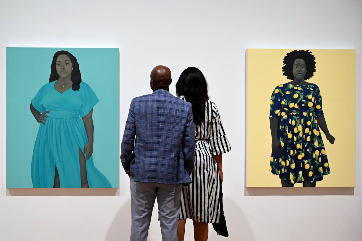Visitors look at “Breonna Taylor” (left) and “She Always Believed the Good about Those She Loved” in the “American Sublime” exhibition at the High Museum of Art on Friday, May 15, 2026, in Atlanta. The latter painting features the model who stood in to pose for the portrait of the late Breonna Taylor. (Hyosub Shin/AJC)