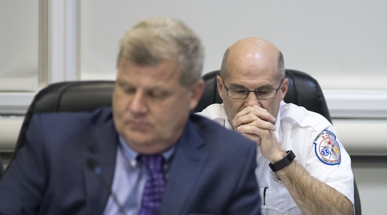 Fayette County 911 communications center director Bernard “Buster” Brown, right, listens as former employees of his communications team make public comments alleging he created a hostile work environment during a Fayette County commissioners meeting, Thursday, Feb. 8, 2018. ALYSSA POINTER / ALYSSA.POINTER@AJC.COM