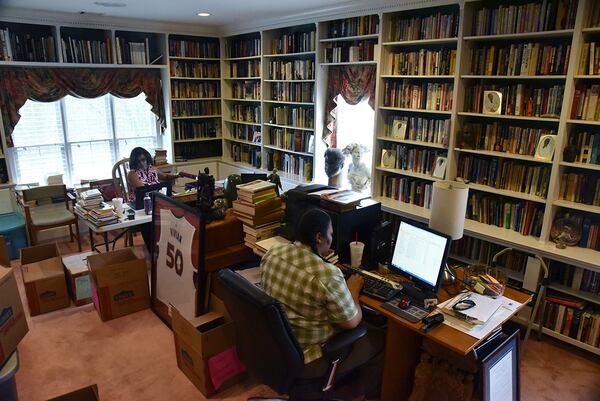 C.T. Vivian's daughter Charisse Thornton (background) and Dawnn Mitchell work on checking inventory in C.T. Vivian's home library on Tuesday, July 25, 2017. The new library will be housed in the new Cook Park in Vine City. Vivian lived in the same Vine City neighborhood that will border Cook Park where his library is to be constructed under a 101-foot Peace Column. The 6,000 volume C.T. Vivian Library is one of the most impressive private collections in the city. HYOSUB SHIN / HSHIN@AJC.COM