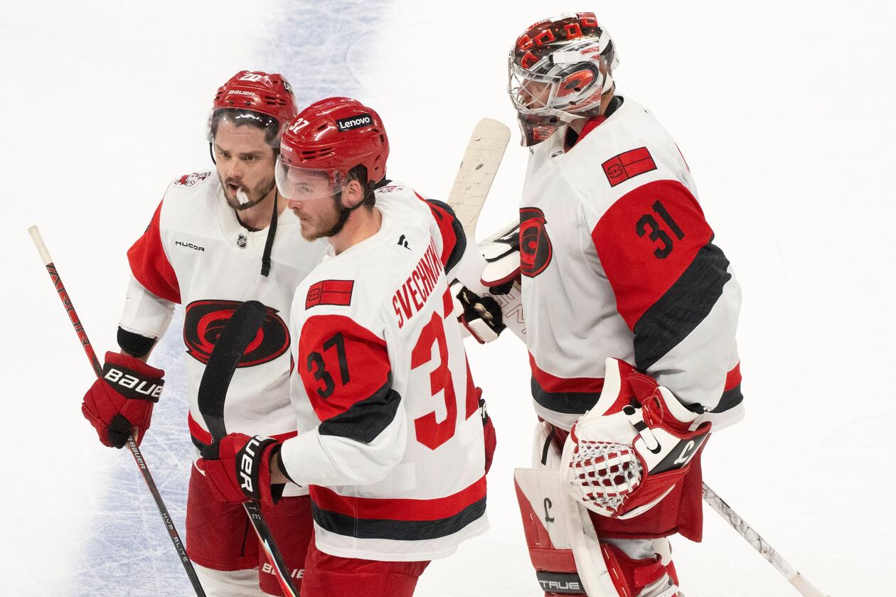 Carolina Hurricanes' Sebastian Aho (20) and Andrei Svechnikov (37) celebrate in front of Hurricanes goaltender Frederik Andersen (31) after the winning goal by Aho in overtime of Game 3 of the Eastern Conference finals NHL hockey Stanley Cup playoff series against the Montreal Canadiens in Montreal, Monday, May 25, 2026. (Christinne Muschi/The Canadian Press via AP)