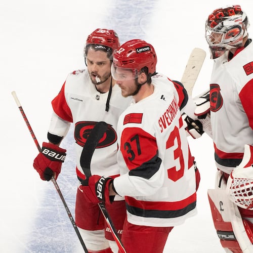 Carolina Hurricanes' Sebastian Aho (20) and Andrei Svechnikov (37) celebrate in front of Hurricanes goaltender Frederik Andersen (31) after the winning goal by Aho in overtime of Game 3 of the Eastern Conference finals NHL hockey Stanley Cup playoff series against the Montreal Canadiens in Montreal, Monday, May 25, 2026. (Christinne Muschi/The Canadian Press via AP)
