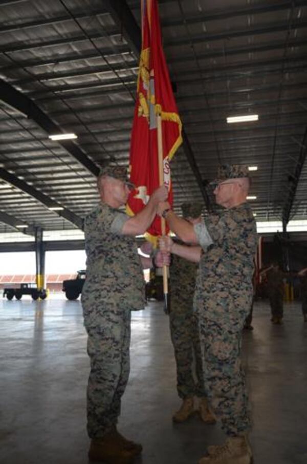 Maj. Gen. Joseph Shrader, right, passes the Marine Corps flag to Maj. Gen. Keith Reventlow, incoming commander of Marine Corps Logistics Command, during a change of command ceremony at Marine Corps Logistics Base-Albany. (Courtesy of Alan Mauldin)