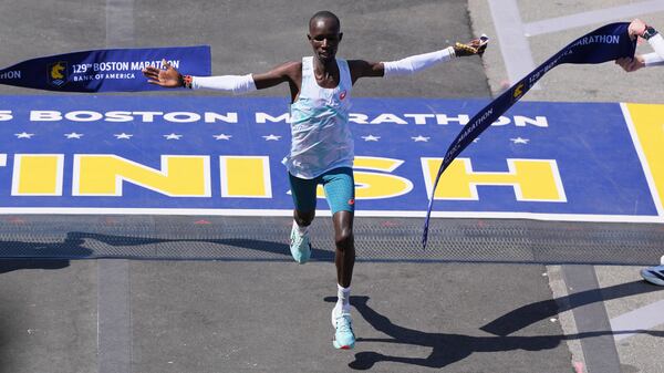 John Korir, of Kenya, breaks the tape to win the Boston Marathon, Monday, April 21, 2025, in Boston. (AP Photo/Charles Krupa)