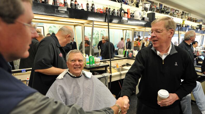 110108 Atlanta: U.S Senator Johnny Isakson, right shakes hands with a patron as Governor elect Nathan Deal gets a hair cut from Thomas Barber Shop owner, Tommy Thomas Saturday January 8, 2011. Brant Sanderlin bsanderlin@ajc.com