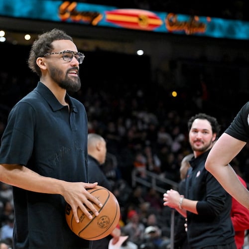 Hawks guard Trae Young holds a basketball during timeout Wednesday, Jan. 7, 2026, against the Pelicans at State Farm Arena in Atlanta. With word of a pending trade imminent, Young sat out the game and later left the bench after the deal became official. (Hyosub Shin/AJC)