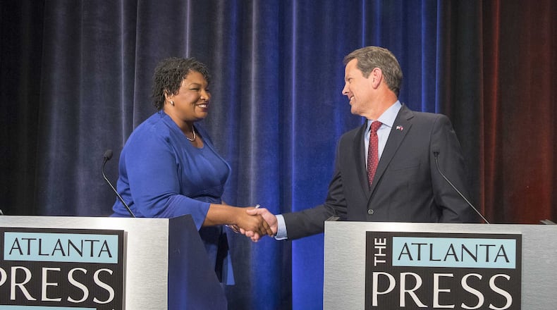 Georgia Democratic gubernatorial nominee Stacey Abrams and Republican nominee Brian Kemp, Georgia’s secretary of state at the time, greet each other before the taping of a debate before teh 2018 election. Two days before Election Day, Kemp’s office announced that it was opening an investigation into the Democratic Party of Georgia of being in volved in a