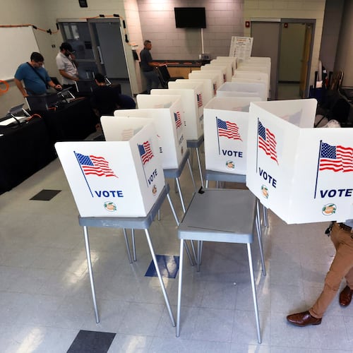 FILE - Lenny Carrillo, from the Orange County Supervisor of Elections Office, sets up voting booths at the Meadow Woods Community Center in Orlando, Fla., Oct. 15, 2024. (Joe Burbank/Orlando Sentinel via AP, File)