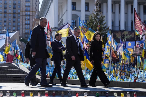 From left, German Chancellor Friedrich Merz, French President Emmanuel Macron and U.K. Prime Minister Keir Starmer, walk in front of the memorial of fallen Ukrainian soldiers at independence square in Kyiv, Ukraine, on Saturday, May 10, 2025. (AP Photo/Evgeniy Maloletka)
