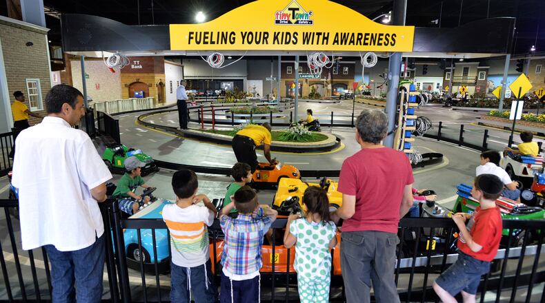 Children learn to respect road signs and other drivers July 8, 2014 at Tiny Towne in Norcross. The facility introduces children ages 3 and older to real-life driving experiences and helps them steer away from dangerous, reckless driving.