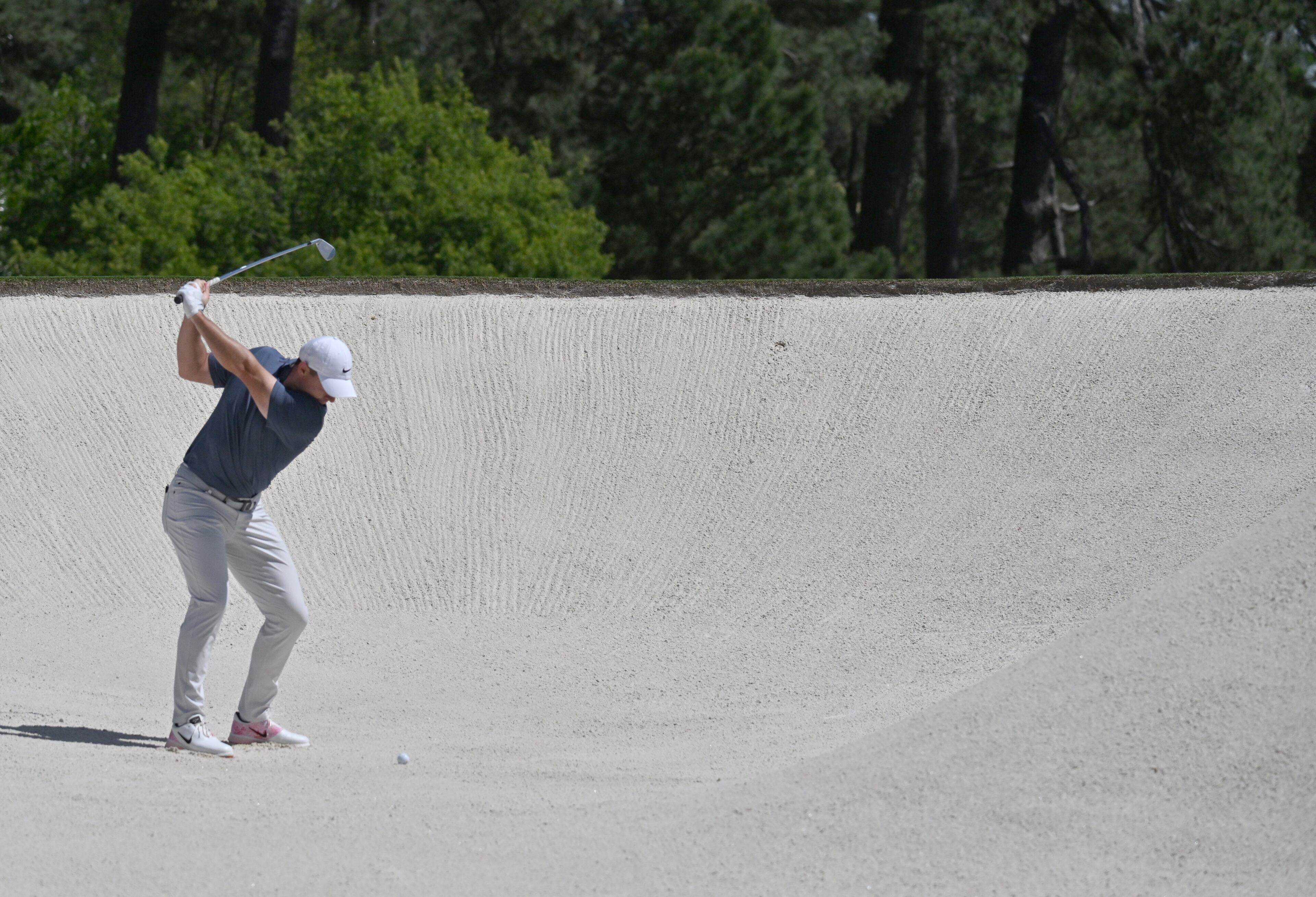 Rory McIlroy hits out of bunker on second hole during final round of the Masters golf tournament, at Augusta National Golf Club, Saturday, April 13, 2025, in Augusta, Ga. (Hyosub Shin / AJC)