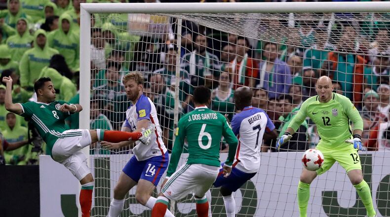 United States goalkeeper Brad Guzan, right, eyes the ball after Mexico’s Marco De la Mora, left, shot trying to score during their World Cup soccer qualifying match at Azteca Stadium in Mexico City, Sunday, June 11, 2017.(AP Photo/Rebecca Blackwell)