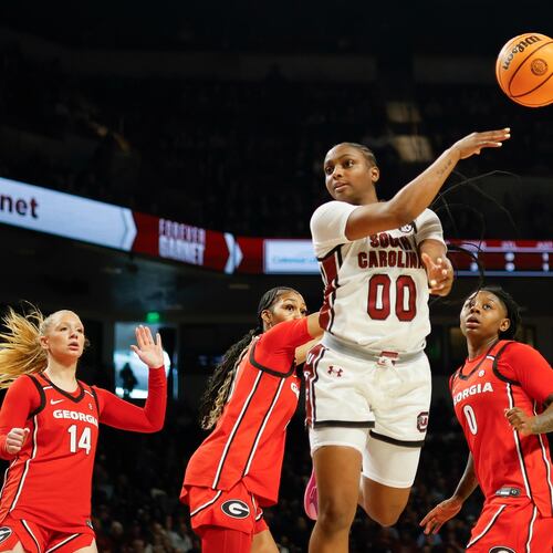 South Carolina guard Ta'Niya Latson (00) passes the ball ahead of Georgia guard Rylie Theuerkauf (14), forward Zhen Craft, second from left, and guard Trinity Turner (0) during the first half of an NCAA college basketball game in Columbia, S.C., Sunday, Jan. 11, 2026. (AP Photo/Nell Redmond)