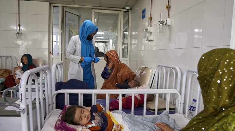 FILE - Afghan women care for their children in the malnutrition ward at Indira Gandhi Children's Hospital in Kabul, Afghanistan, Feb. 15, 2026. (AP Photo/Siddiqullah Alizai, File)