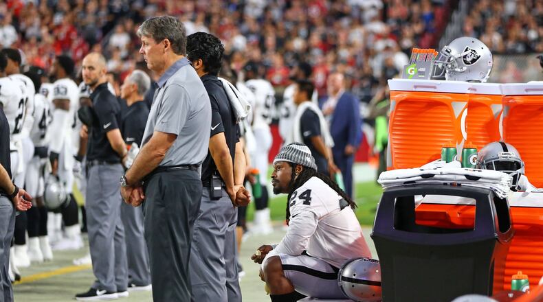 Marshawn Lynch sits on a cooler near the bench during the national anthem during the Oakland Radiers’ first exhibition game against the Arizona Cardinals on Saturday, Aug. 12, 2017