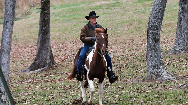 U.S. Senate candidate Roy Moore rides a horse to vote, Dec. 12, 2017, in Gallant, Ala.