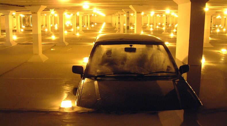 At least a dozen cars were partially submerged underwater Wednesday morning at Dallas Love Field Airport after heavy storms hit the area overnight.