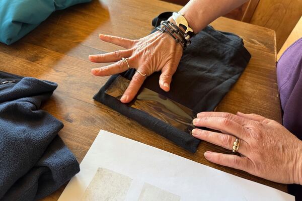 Rachael Z. Miller, founder of the Vermont-based Rozalia Project for a Clean Ocean, conducts a tape test on various clothing items to compare how much each material sheds microfibers on Thursday, April 17, 2025, in Granville, Vt. (AP Photo/Amanda Swinhart)