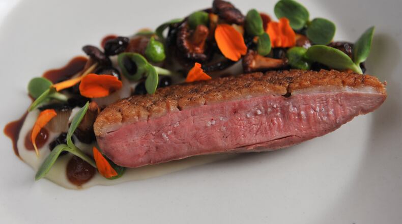 OUTSTANDING RESTAURANT: The husband-and-wife team of Anne Quatrano and Clifford Harrison has kept Westside mainstay Bacchanalia one of the city's top restaurants for more than 20 years (It was the only spot AJC food writer John Kessler awarded four stars to in 2014's Dining Guide). Pictured here is the restaurant's Long Island duck, Summerland Farm onions, preserved chanterelles and currants. (Beckysteinphotography.com)
