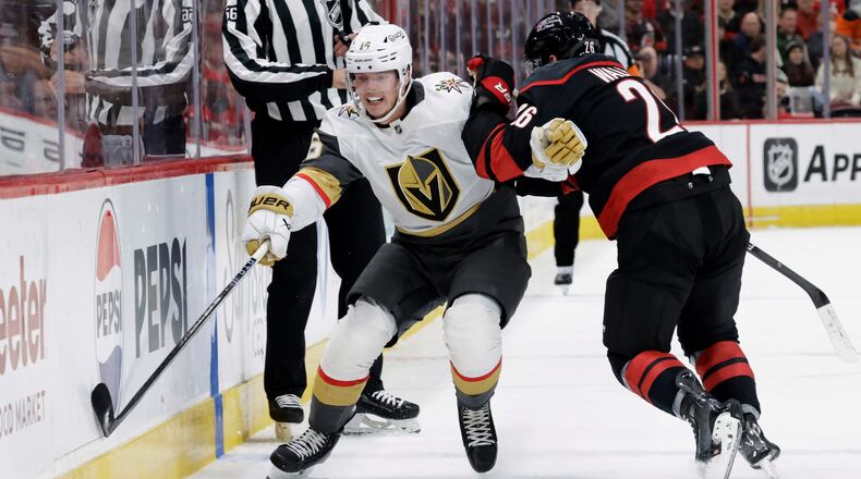 FILE - Vegas Golden Knights right wing Pavel Dorofeyev (16) and Carolina Hurricanes defenseman Sean Walker (26) vie for the puck during the first period of an NHL hockey game Oct. 28, 2025, in Raleigh, N.C. (AP Photo/Chris Seward, File)