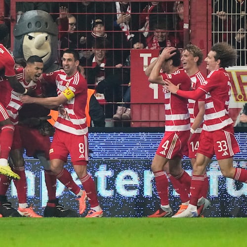Union's Danilho Doekhi celebrates with team mates after scoring his side's second goal during the Bundesliga soccer match between Union Berlin and FC Bayern Munich in Berlin, Germany, Saturday, Nov. 8, 2025. (AP Photo/Martin Meissner)