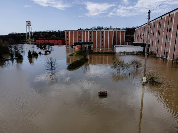In an aerial view, a bourbon barrel floats on the floodwaters of the Buffalo Trace Distillery on Monday, April 7, 2025, in Frankfort, Ky. (AP Photo/Jon Cherry)