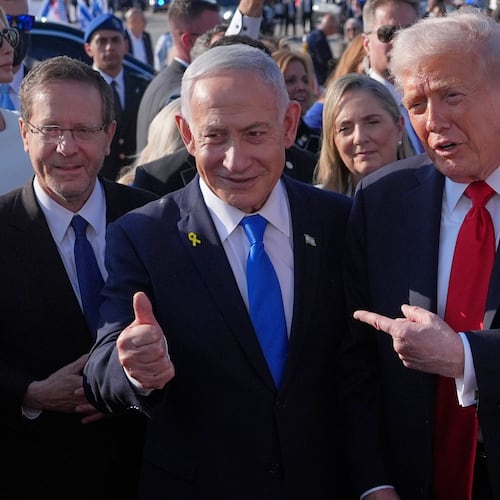 FILE - President Donald Trump poses for a photo with Israel's Prime Minister Benjamin Netanyahu before he boards Air Force One at Ben Gurion International Airport, Oct. 13, 2025, near Tel Aviv, as Israel's President Isaac Herzog watches at left. (AP Photo/Evan Vucci, File)