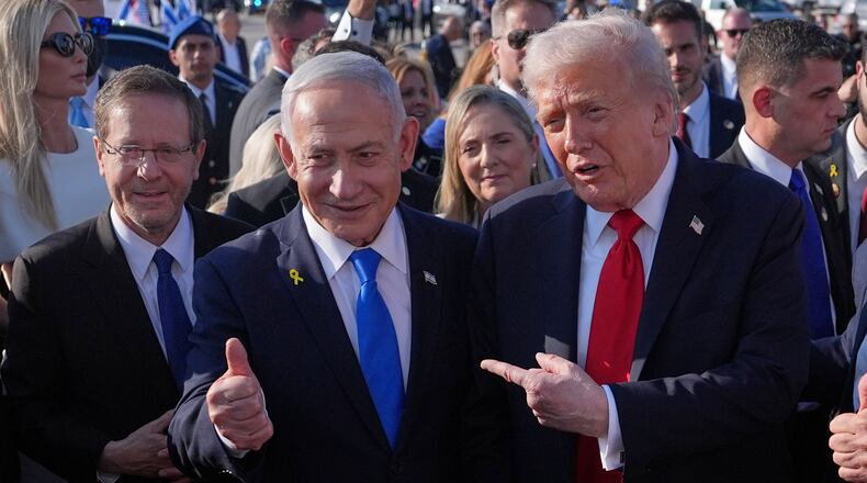FILE - President Donald Trump poses for a photo with Israel's Prime Minister Benjamin Netanyahu before he boards Air Force One at Ben Gurion International Airport, Oct. 13, 2025, near Tel Aviv, as Israel's President Isaac Herzog watches at left. (AP Photo/Evan Vucci, File)