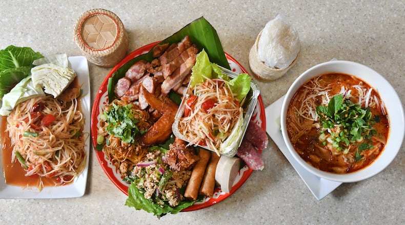 Among the dishes served at Snackboxe Bistro in Duluth are, from left, tham mak hoong (papaya salad), Lao platter and khao poon (red curry noodle soup). Food styling by Vanh Sengaphone and Thip Athakhanh. (CHRIS HUNT FOR THE ATLANTA JOURNAL-CONSTITUTION)