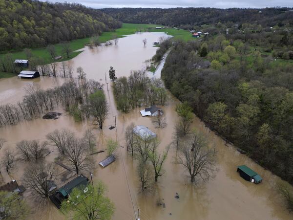 the rising waters of Cedar Creek and the Kentucky River overflow their banks, Sunday, April 6, 2025, in Monterey, Ky. (AP Photo/Carolyn Kaster)