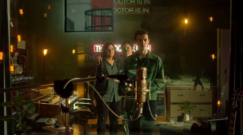 The film "Glitter & Doom" featured cameo appearances by the Indigo Girls, including Amy Ray (left) with main actors Alex Diaz (middle) and Alan Cammish (right). MUSIC BOX FILMS