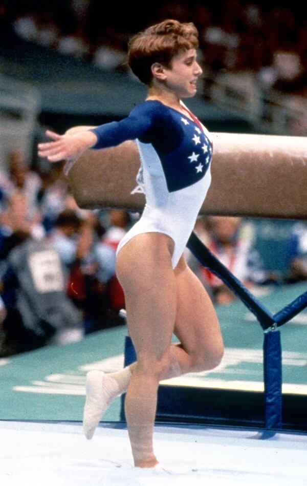 Although injured, Kerri Strug holds her landing from the vault to ensure the gold medal for the U.S. in 1996. (Jean Shifrin/AJC 1996)