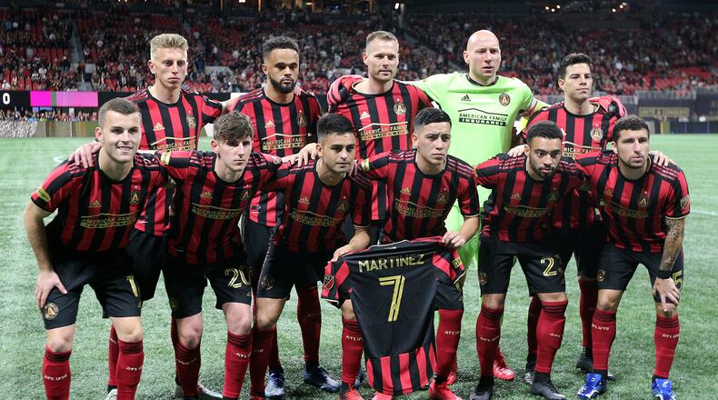March 8, 2020 Atlanta: Atlanta United players hold a Martinez jersey as they take the field to play FC Cincinnati in a MLS soccer match on Saturday, March 8, 2020, in Atlanta.   Curtis Compton ccompton@ajc.com
