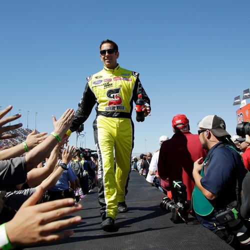 FILE - Greg Biffle greets fans during drivers introduction before the NASCAR Sprint Cup Series auto race at Chicagoland Speedway, Sept. 20, 2015, in Joliet, Ill. (AP Photo/Nam Y. Huh, File)