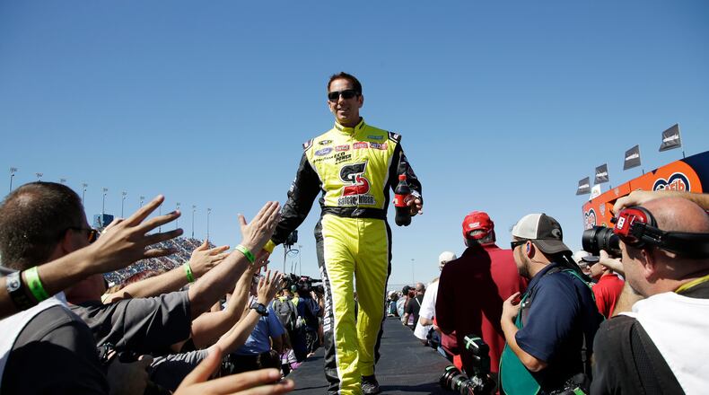 FILE - Greg Biffle greets fans during drivers introduction before the NASCAR Sprint Cup Series auto race at Chicagoland Speedway, Sept. 20, 2015, in Joliet, Ill. (AP Photo/Nam Y. Huh, File)