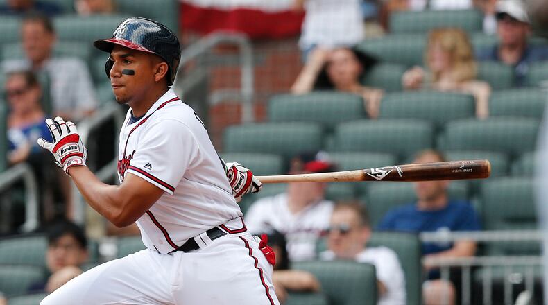 Atlanta Braves' Johan Camargo follows through on his first Major League base hit in the eighth inning against the San Diego Padres Sunday, April 16, 2017, in Atlanta. Atlanta won 9-2.