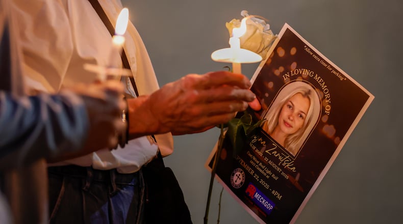 FILE - Community members hold candles as they gather for a vigil honoring the life of Iryna Zarutska, who was fatally stabbed on a commuter train, Sept. 22, 2025, in Charlotte, N.C. (AP Photo/Nell Redmond, File)