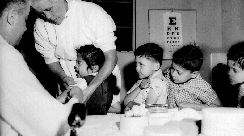 First and second graders at a school in Los Angeles were among the first to be innoculated with the new polio vaccine in 1955. Georgia health experts say that a new case of polio detected in New York is a wake-up call. (AP file)