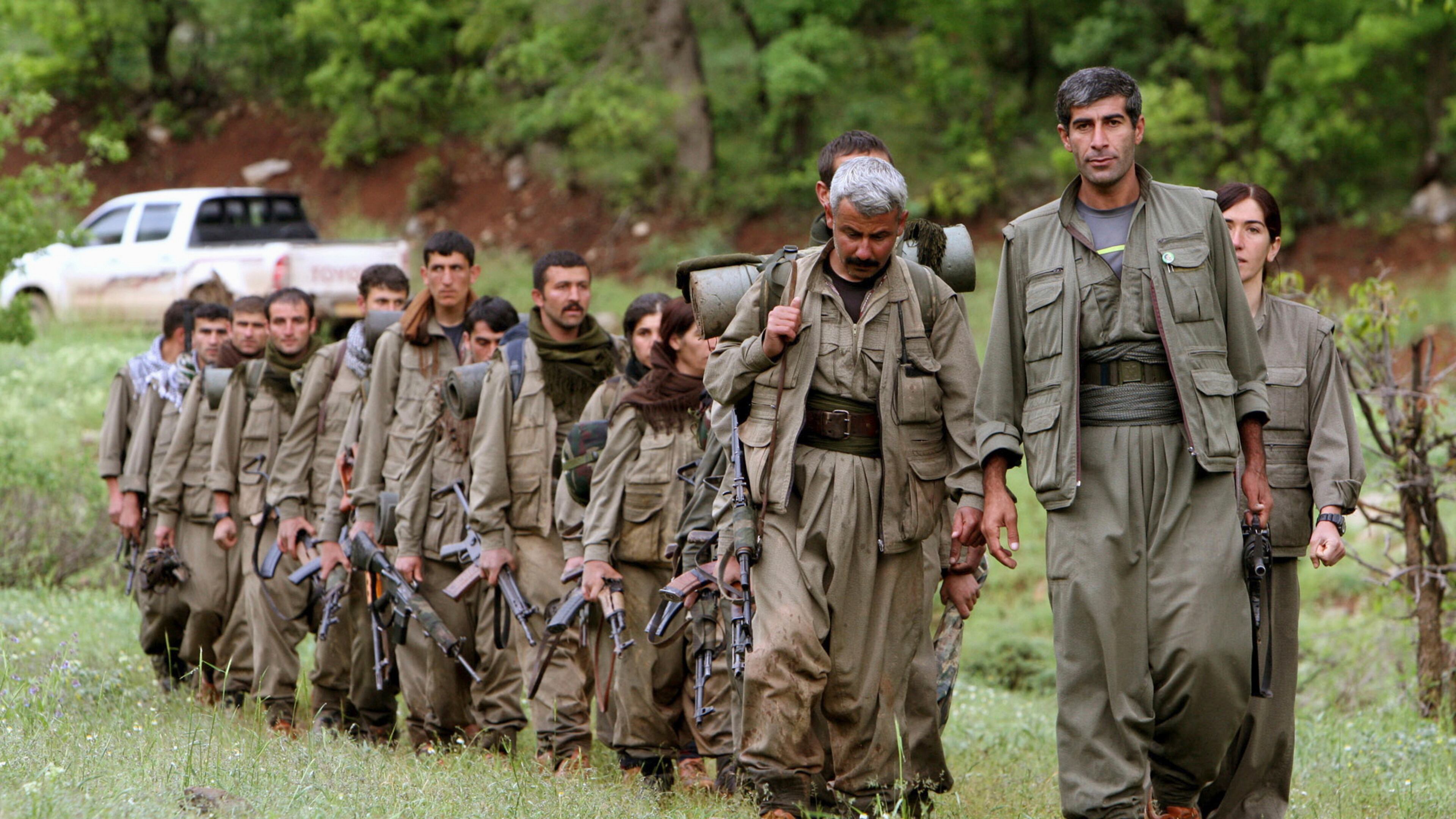 FILE - A group of armed Kurdish fighters from the Kurdistan Workers Party (PKK) enter northern Iraq in the Heror area, northeast of Dahuk, 260 miles (430 kilometers) northwest of Baghdad, Iraq, May 14, 2013. (AP Photo/Ceerwan Aziz, File)