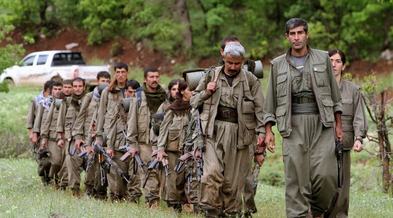 FILE - A group of armed Kurdish fighters from the Kurdistan Workers Party (PKK) enter northern Iraq in the Heror area, northeast of Dahuk, 260 miles (430 kilometers) northwest of Baghdad, Iraq, May 14, 2013. (AP Photo/Ceerwan Aziz, File)