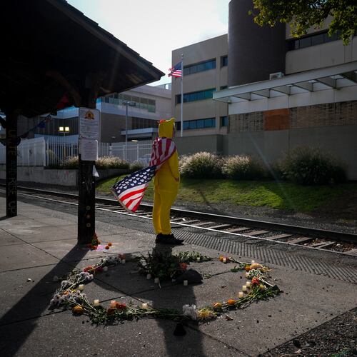 FILE - Jack Dickinson, dressed in a chicken costume, looks to other protesters outside a United States Immigration and Customs Enforcement (ICE) facility in Portland, Ore., Monday, Oct. 20, 2025. (AP Photo/Jenny Kane,File)