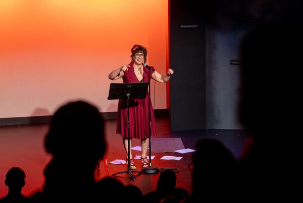 “Too Fast, Too Festivus” cast member Gina Rickicki, shown at a Write Club storytelling competition, says, "The more people are able to experience laughter, joy and relief as a group, the stronger we are.” (Jenni Girtman for the AJC)