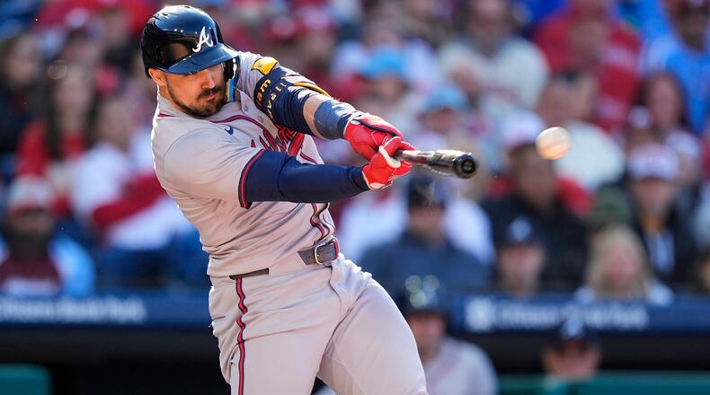Atlanta Braves' Adam Duvall hits a two-run double off Philadelphia Phillies pitcher Matt Strahm during the seventh inning of an opening-day baseball game, Friday, March 29, 2024, in Philadelphia. (AP Photo/Matt Slocum)