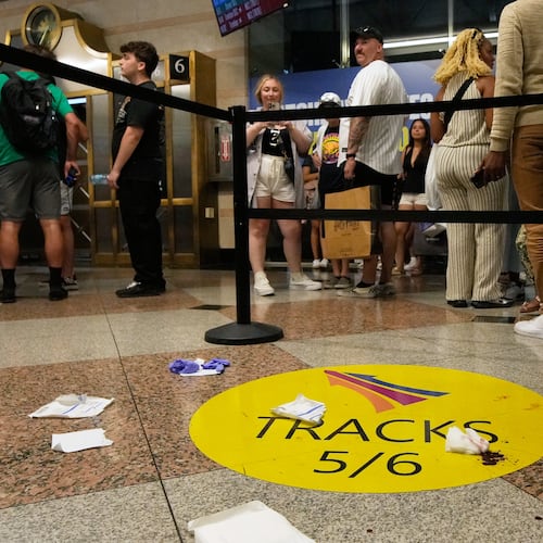People stand near an area roped off after a stabbing at Penn Station on Sunday, June 7, 2026, in New York. (AP Photo/Ross D. Franklin)