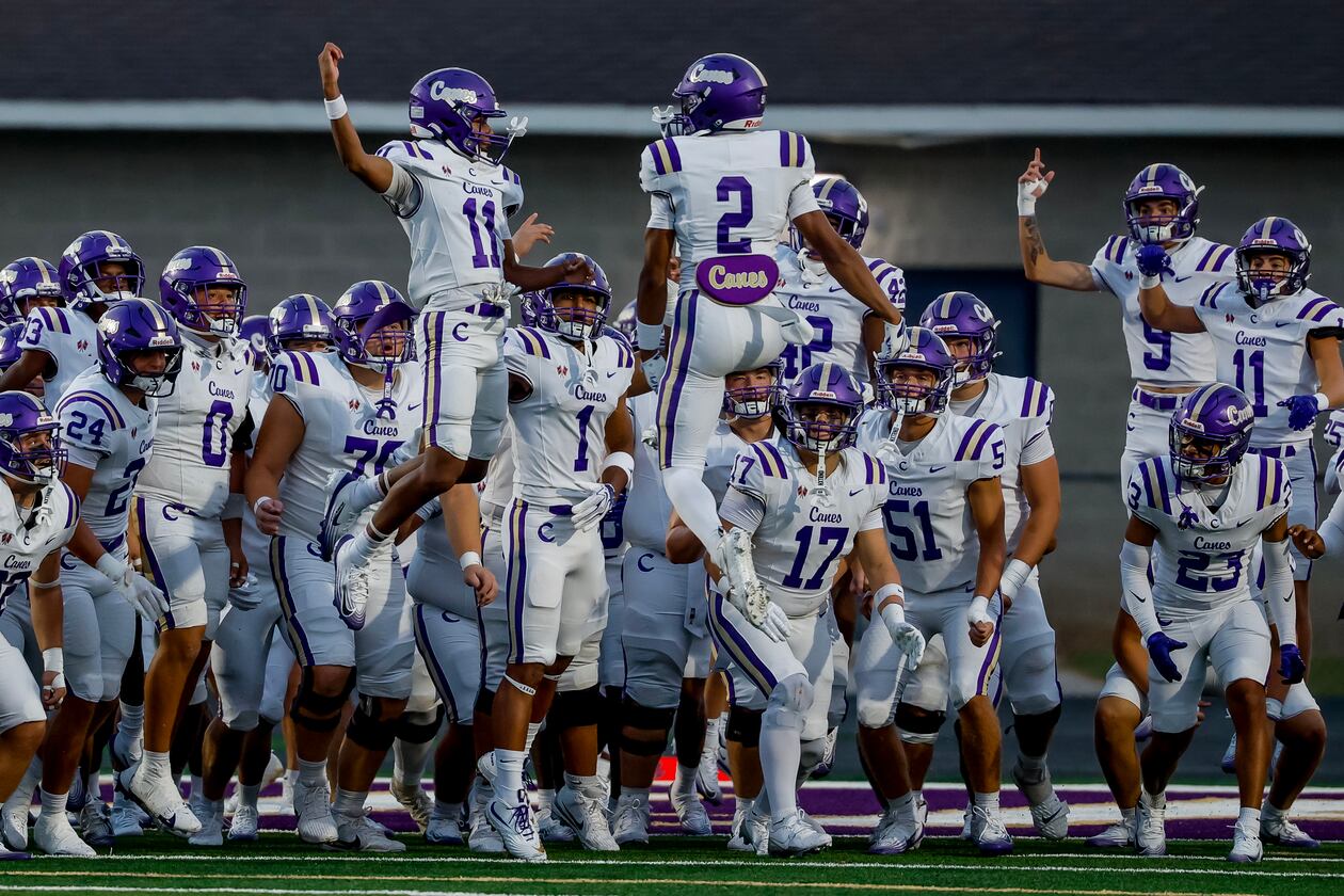 Cartersville’s Lance Tippett (left) and Grayson Warmack lead their teammates onto the field before their game against Hiram on Friday, Aug. 21, 2026, in Hiram. (Erik S. Lesser for the AJC)