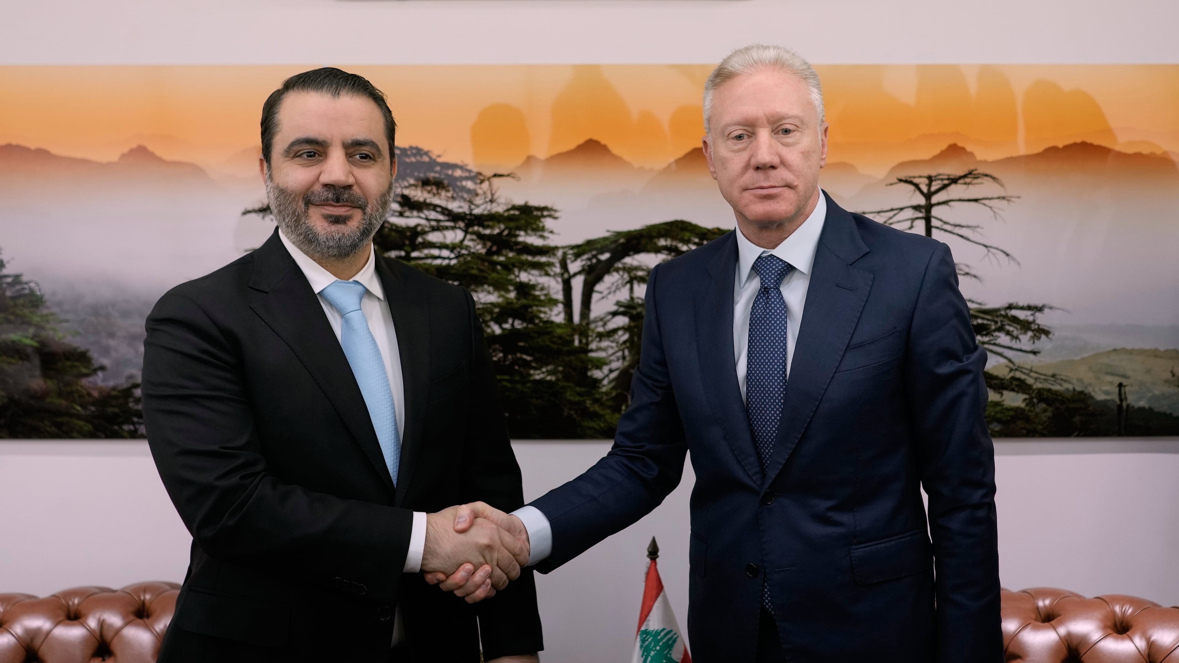 Lebanese Foreign Minister Youssef Rajji, right, shakes hands with his Syrian counterpart Asaad al-Shibani before their meeting in Beirut, Lebanon, Friday, Oct. 10, 2025. (AP Photo/Hassan Ammar)
