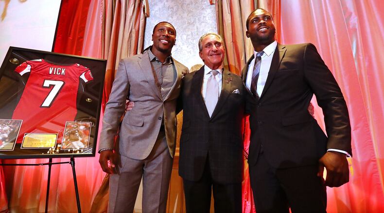 June 12, 2017, Atlanta: Atlanta Falcons owner Arthur Blank honors former Falcons quarterback Michael Vick (right) and wide receiver Roddy White as they officially retire from the NFL on Monday, June 12, 2017, in Atlanta. Curtis Compton/ccompton@ajc.com