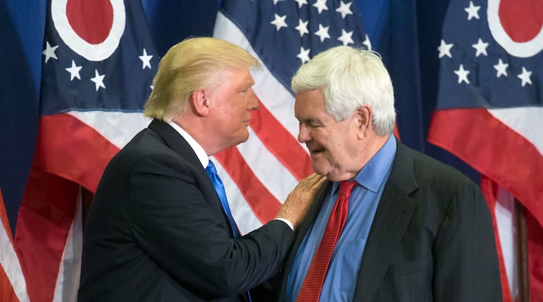 Donald Trump and former House Speaker Newt Gingrich share the stage during a campaign rally in Cincinnati. (AP Photo/John Minchillo)