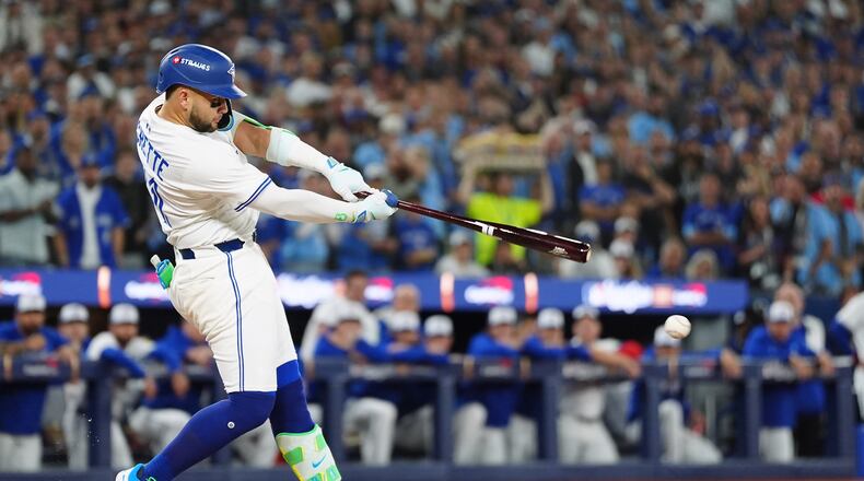 Toronto Blue Jays' Bo Bichette hits a single against the Los Angeles Dodgers during the first inning of Game 1 of baseball's World Series, Friday, Oct. 24, 2025, in Toronto. (Frank Gunn/The Canadian Press via AP)