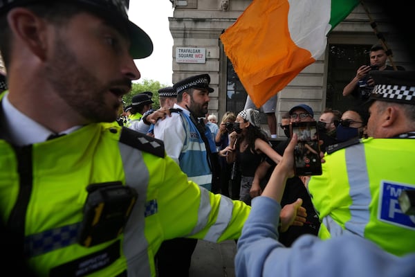 Police and demonstrators confront each other during a protest by Palestine Action group in London, Monday, June 23, 2025. (AP Photo/Frank Augstein)